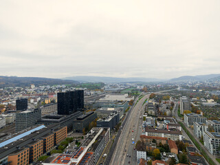 Naklejka premium Aerial view over Swiss City of Zürich with cityscape at District of Altstetten on a cloudy autumn afternoon. Photo taken November 11th, 2024, Zurich, Switzerland.