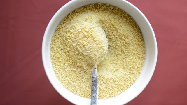 Yellow garri in a white bowl, top view of nigerian garri in a ceramic bowl, fried cassava, garri for eba