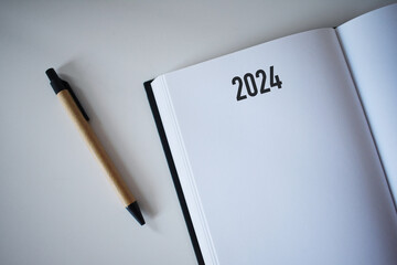 2024 calendar book and pencil on desk