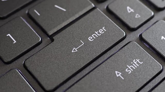 Close up view of finger pressing laptop enter button, notebook keyboard. Digital confirmation, sending email message, online office work, input data.