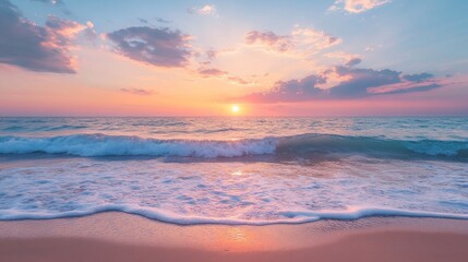Fototapeta premium A picturesque sunset over a calm ocean with gentle waves crashing on the sandy beach.