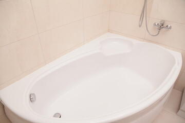 Interior of Modern Bathroom. Corner Acrylic Bath.