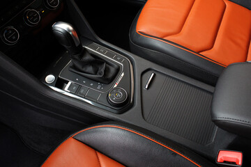 Automatic gearbox of a modern sport car. Gear shift in sports SUV. Car interior details made of...