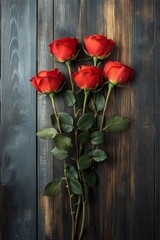 A beautiful bouquet of red roses arranged elegantly on a wooden surface