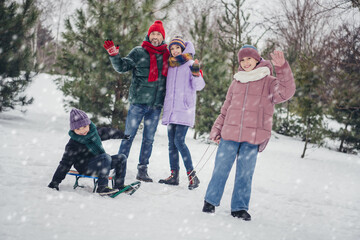 Photo of sweet charming husband wife small kid wear windbreaker sledding spending time together outside urban city park
