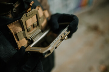 Soldier wearing tactical vest holding empty phone case