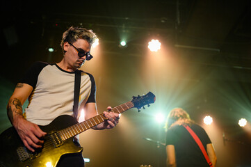 Guitarist playing electric guitar on stage during concert