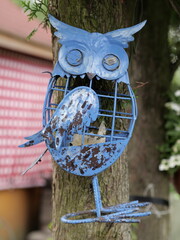blue metal owl in the shape of a cage © Piotr