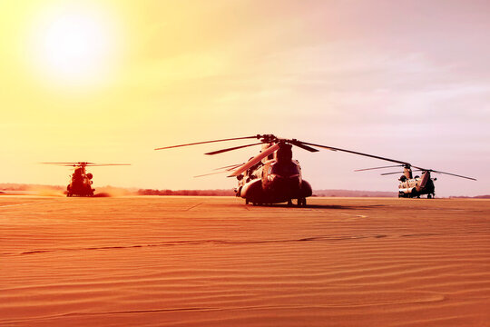 Three chinook helicopters at an air base with strong sunshine