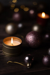 photo A Cozy and Atmospheric Scene with Flickering Candlelight Surrounded by Elegant Festive Ornaments and Warm Lighting on a Dark Wooden Surface for Seasonal Decor Inspiration