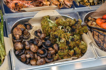 Mouthwatering selection of grilled vegetables including mushrooms, broccoli, and more, expertly prepared and arranged. Perfect for a healthy meal or barbeque celebration.