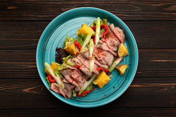Sliced smoked meat with vegetables