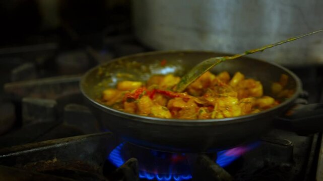 Cooking and mixing ingredients in a frying pan in a professional kitchen slow motion