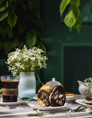 Delicious easter egg-shaped cookies with coffee enjoying a relaxing afternoon