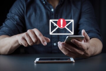 SMS spam, fake text message phishing from scammer concept. System hacked red warning alert, email hack, scam malware spreading virus on message alert virtual on mobile phone screen in person hand.