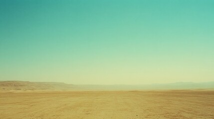 Obraz premium An expansive desert under a vast, clear sky where the horizon blurs into infinity, evoking feelings of solitude and awe.