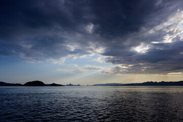 Komodo National Park Seascape with Dramatic Sky and Light Rays in Flores, Indonesia
