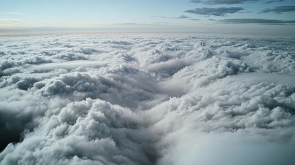 Obraz premium A breathtaking view of fluffy white clouds spread across the vast sky, creating an ethereal sea of tranquility.