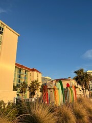 Colorful Surfboards by Beachfront Buildings at Sunset