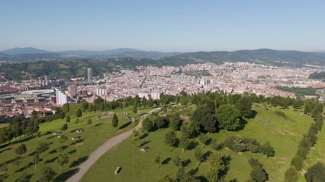 Aerial footage of Mount Cobetas with the cityscape of Bilbao in the background in Biscay, Spain