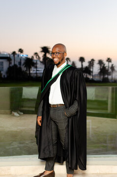 Portrait of university graduate with flash taken at golden hour