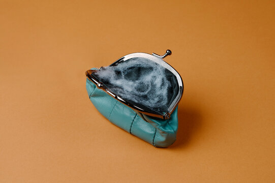 blue leather purse with some cobwebs