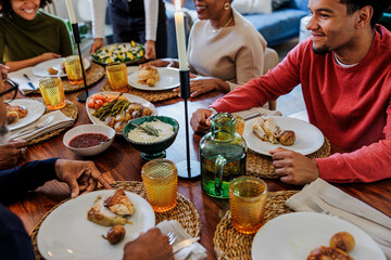 Happy family enjoying thanksgiving dinner together around table