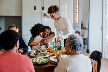 Happy family sharing christmas meal celebrating with hugs and love