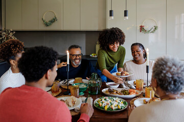 Happy family having dinner together at home for christmas time