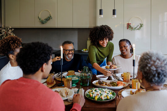 Happy family having dinner together at home for christmas time