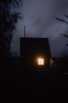 Silhouette of a country house late in the evening