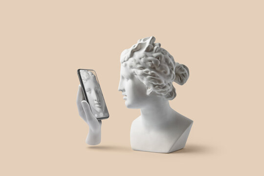 Gypsum hand holding smartphone with reflection of bust on screen