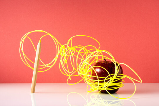 Back to school, abstract concept. Yellow cable, apple and coloring pen