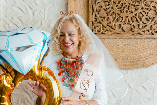 Celebrating Bachelorette Party with Balloon and Veil