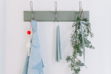 Three hooks with items hanging on white wall decor