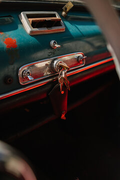 Close-up of vintage car dashboard with keys in ignition