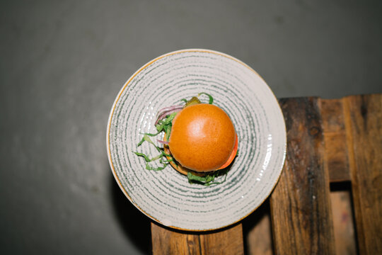 Top view of fresh burger on a plate with grey design