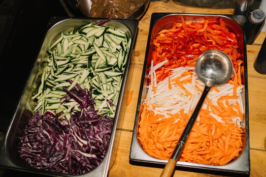 Vegetable strips prepared for wok cooking in trays