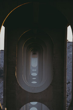 Rhythmic arches of the bridge at sunset.
