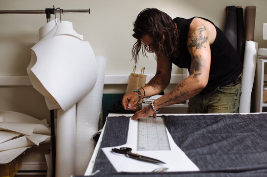 Brunette man creating clothes