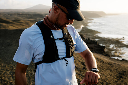 Runner checks his fitness with his smartwatch during morning training