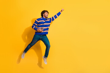 Full size photo of pretty young male hold device flying superhero wear trendy blue striped outfit...