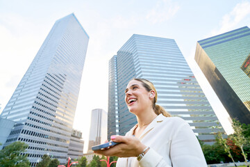Happy business woman sending voice message 