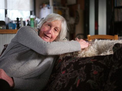An older transgender woman with dog at home