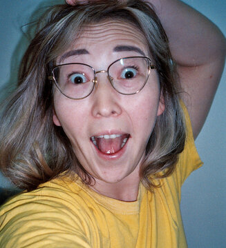 Excited Woman in Yellow Shirt
