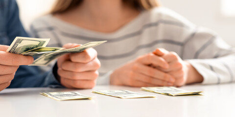 Coronavirus and financial problems. Young family counting poor money savings at home, close up