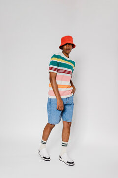 Man wearing summer clothes and red bucket hat looking at camera