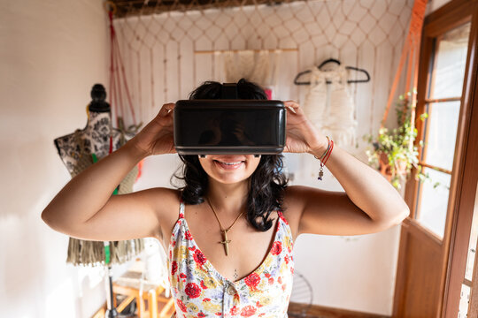 Fashion designer using virtual reality glasses in her studio