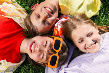 Portrait Smiling Kids Lying on Green Grass