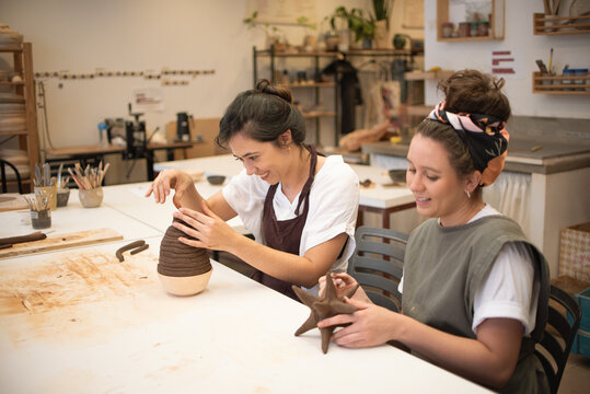 Two friends taking a sculpture class together